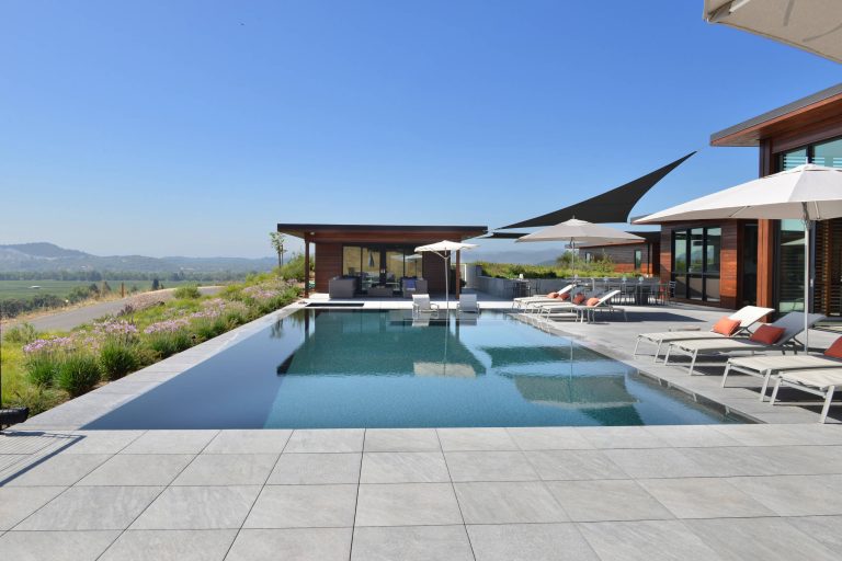 We installed the unseen Buzon roof deck pedestals and the Italian porcelain pavers in this 5,000 sf outdoor roof deck and pool patio.