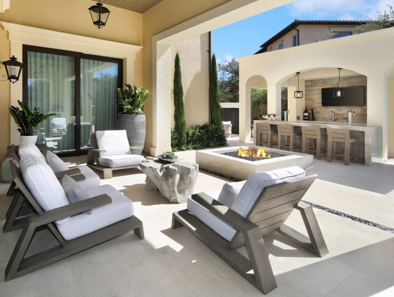 Inspiration for a contemporary concrete patio remodel in Orange County with a fire pit and a roof extension