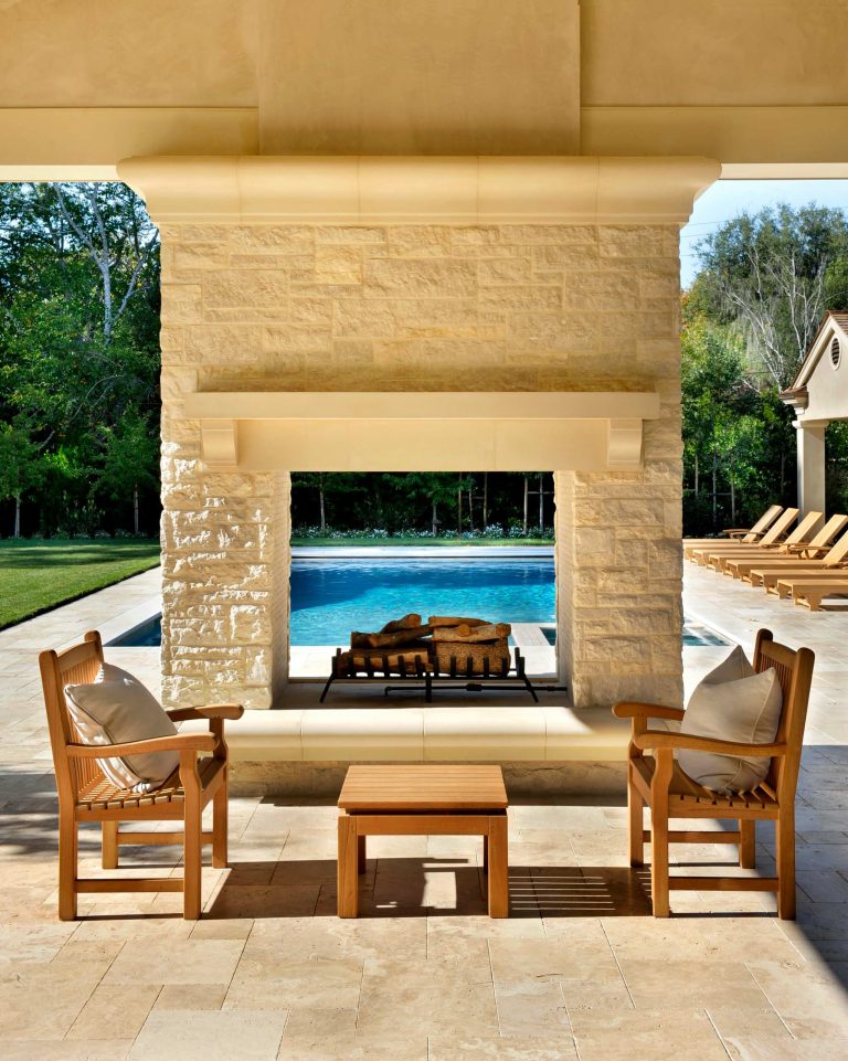 Designed and built by Pacific Peninsula Group. Fireplace with views of pool. Photography by Bernard Andre.