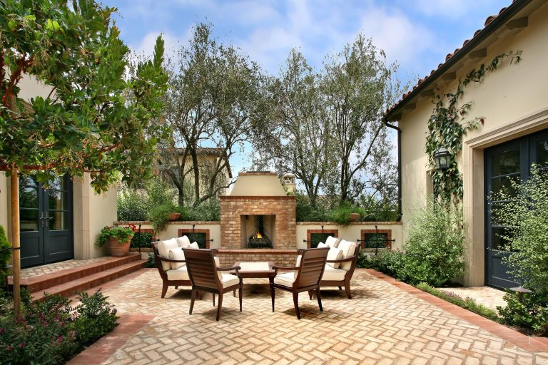 Tuscan courtyard patio photo in Los Angeles with a fire pit