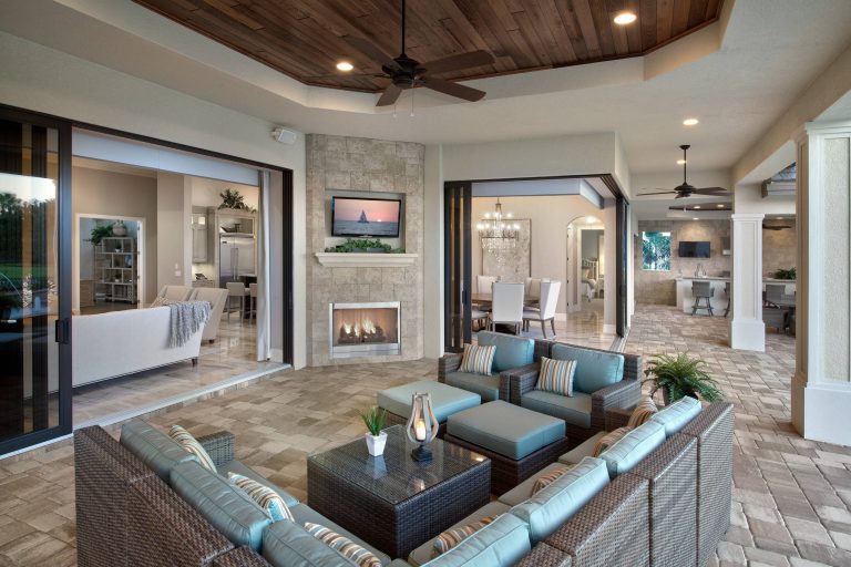 Large tuscan stone back porch photo in Miami with a fire pit and a roof extension by Norris Furniture & Interiors | Outdoor Photos | Porch | Landscaping | Landscape Design | Outdoor Living Space | Porch Design Ideas | Outdoor Living Space Ideas | Backyard Design