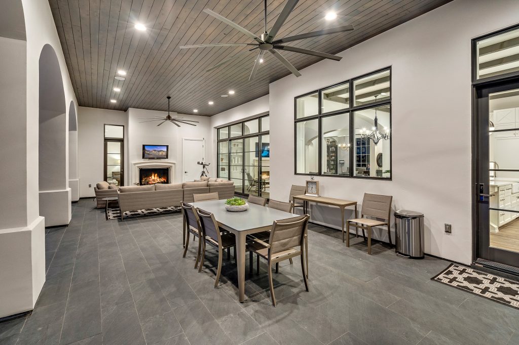 Large tuscan backyard tile patio photo in Austin with a fire pit and a roof extension