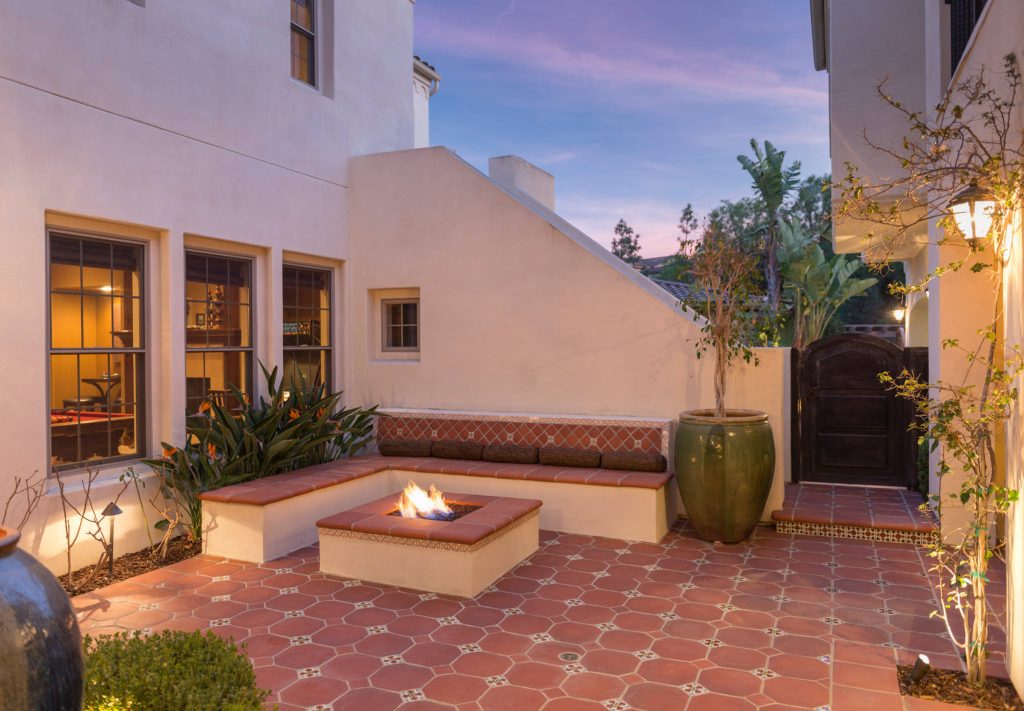 This is the homes inner courtyard featuring Terra-cotta tile paving with hand-painted Mexican tile keys, a fire pit and bench.

Photographer: Riley Jamison
Realtor: Tim Freund,
website: tim@1000oaksrealestate.com by The Design Studio of Wendy Harper | Fire Pits|Backyard Design|Outdoor Living Spaces|Landscape Design|Backyard Ideas|Landscaping|Landscaping Ideas|Landscape Installation|Fire Feautures|Fire Pit