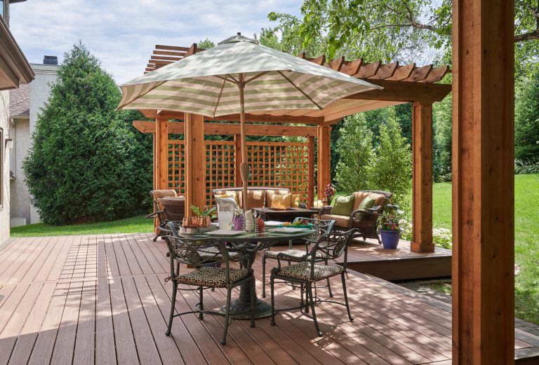Deck - traditional ground level deck idea in Minneapolis with a fire pit and a pergola