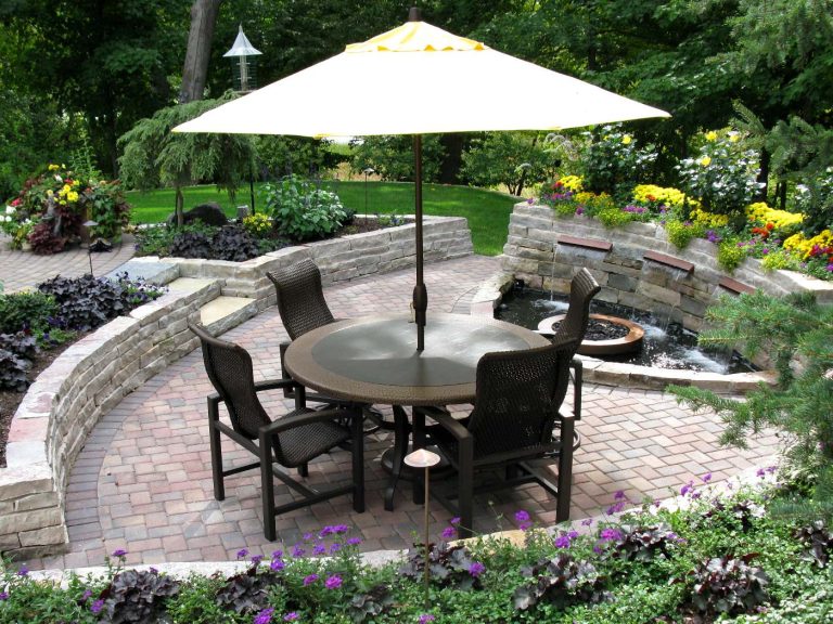 Paver patio enclosed by limestone walls