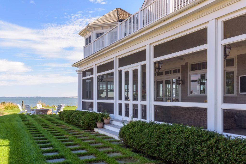 This is an example of a coastal side yard landscaping in New York with a fire pit.