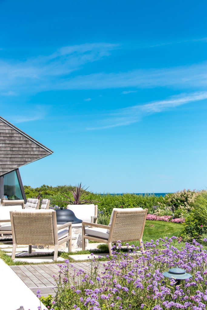 Inspiration for a coastal backyard patio remodel in New York with a fire pit and no cover