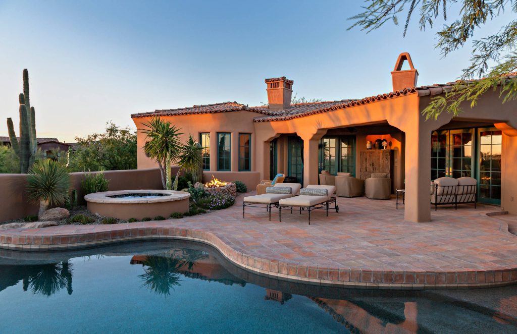 Southwest backyard patio photo in Phoenix with a fire pit and a roof extension