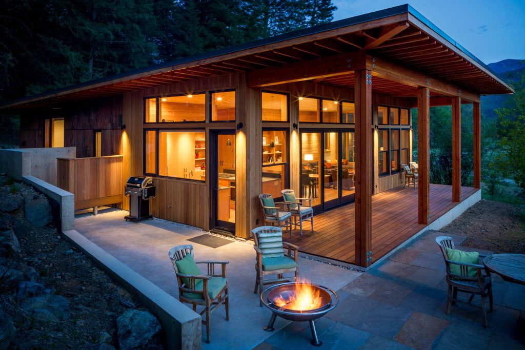 Patio - mid-sized rustic backyard tile patio idea in Seattle with a fire pit and a roof extension