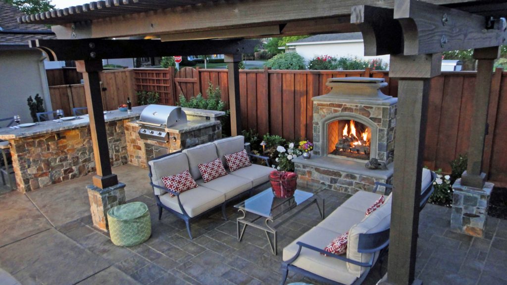 This small backyard has all the desired key elements in three separate rooms. Outdoor kitchen, fireplace, fire pit, shade arbor and bar seating. Paver & stained concrete patio, outdoor lighting, swimming pool & spa, outdoor heater, waterfall, trellises and fully landscaped. by Alderland - SF Bay Area Pool & Landscape Co. | Fire Pits|Backyard Design|Outdoor Living Spaces|Landscape Design|Backyard Ideas|Landscaping|Landscaping Ideas|Landscape Installation|Fire Feautures|Fire Pit