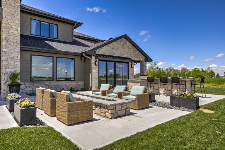 Inspiration for a timeless backyard concrete paver patio remodel in Omaha with a fire pit and no cover