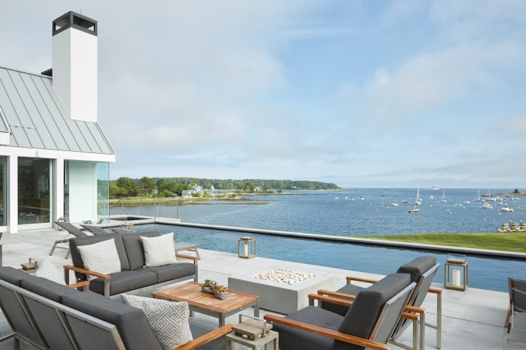 Example of a large trendy backyard concrete patio design in Portland Maine with a fire pit and no cover