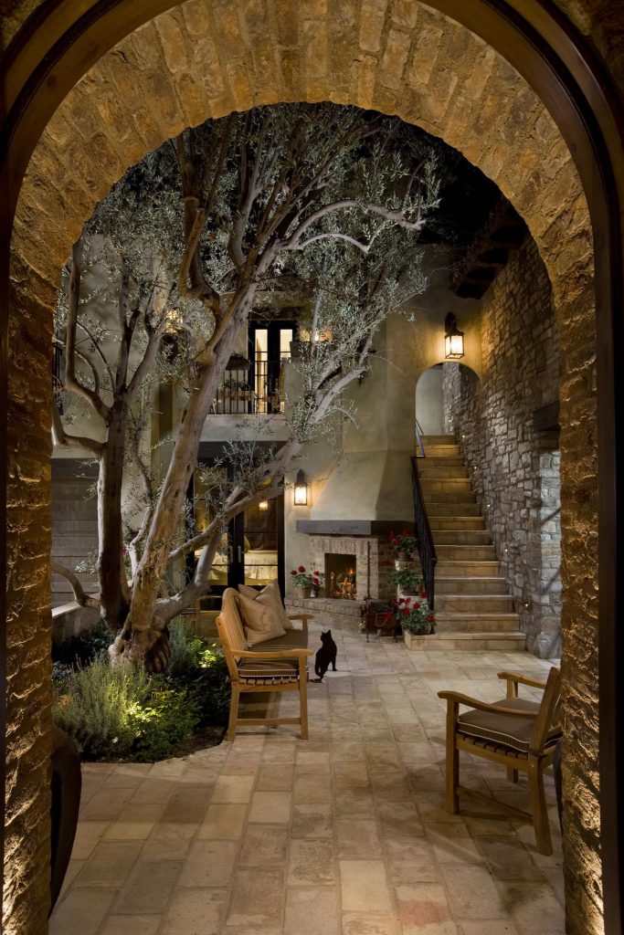 “This design originated with the client’s desire to duplicate the warmth of Tuscan Architecture,” says Stolz. “The vision that South Coast Architects set forth was to create the feel of an old Tuscan Village as a private residence at their golf community, ‘The Hideaway’ in La Quinta, California. However, we had to keep in mind that we were still designing for a desert lifestyle, which meant an emphasis on indoor/outdoor living and capturing the spectacular views of the golf course and neighboring mountains,” Stolz adds.

“The owners had spent a lot of time in Europe and knew exactly what they wanted when it came to the overall look of the home, especially the stone,” says Muth. “The mason ended up creating a dozen mock-ups of various stone profiles and blends to help the family decide what really worked for them. Ultimately, they selected Eldorado Stone’s Orchard Cypress Ridge profile that offers a beautiful blend of stone sizes and colors.”

“The generous use of Eldorado Stone with brick detailing over the majority of the exterior of the home added the authenticity and timelessness that we were striving for in the design,” says Stolz.
“Our clients want the very best, but if we can duplicate something and save money, what client would say no? That’s why we use Eldorado Stone whenever we can. It gives us the opportunity to save money and gives clients exactly the look they desire so we can use more of their budget in other areas.”

Stolz explained that Eldorado Stone was also brought into the interior to continue that feel of authenticity and historical accuracy. Stone is used floor to ceiling in the kitchen for a pizza oven, as well as on the fireplace in the Great Room and on an entire wall in the master bedroom. “Using a material like Eldorado Stone allows for the seamless continuation of space” says Stolz.

“Stone is what made the house so authentic-looking” says Muth. “It’s such an integral part of the house that it either was going to be a make or break scenario if we made the wrong choice. Luckily, Eldorado Stone really made it!”

Eldorado Stone Profile Featured: Orchard Cypress Ridge with a khaki grout color (overgrout technique)

Eldorado Brick Profile Featured: Cassis ModenaBrick with a khaki grout color (overgrout technique)

Architect: South Coast Architects
Website: www.southcoastarchitects.com

Builder: Andrew Pierce Corporation, Palm Desert, CA
Website: www. andrewpiercecorp.com

Mason: RAS Masonry, Inc. Bob Serna, Corona, CA
Phone: 760-774-0090

Photography: Eric Figge Photography, Inc. by Eldorado Stone | Fire Pits|Backyard Design|Outdoor Living Spaces|Landscape Design|Backyard Ideas|Landscaping|Landscaping Ideas|Landscape Installation|Fire Feautures|Fire Pit