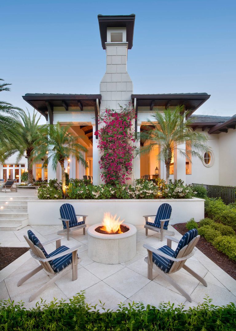Inspiration for a large tropical backyard stone patio remodel in Miami with a fire pit and no cover