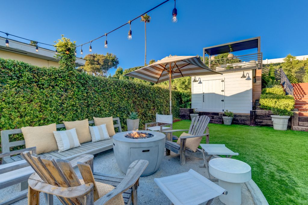 Patio - transitional backyard gravel patio idea in San Diego with a fire pit and no cover