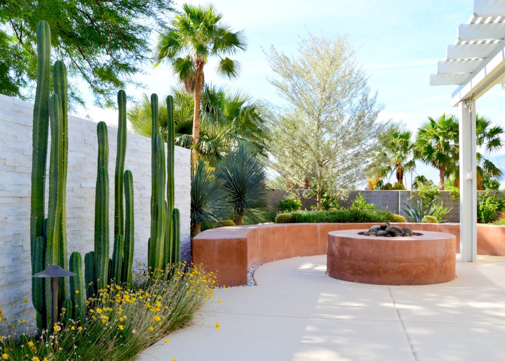 Example of a southwest backyard concrete patio design in Other with a fire pit and no cover
