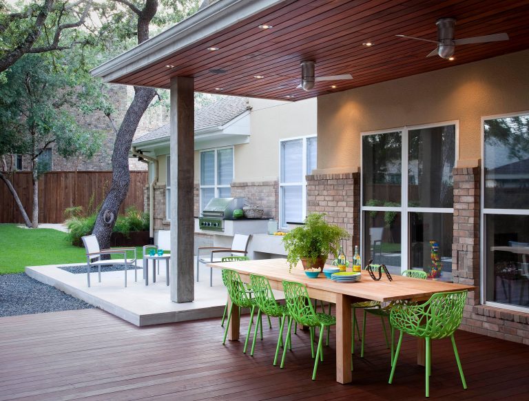 casual dining under a tigerwood ceiling on an ipe deck adjacent to a light limestone patio with an outdoor kitchen for a chef

designed & built by austin outdoor design
photo by ryann ford by austin outdoor design | Outdoor Kitchens | Backyard Design | Outdoor Living Spaces | Landscape Design