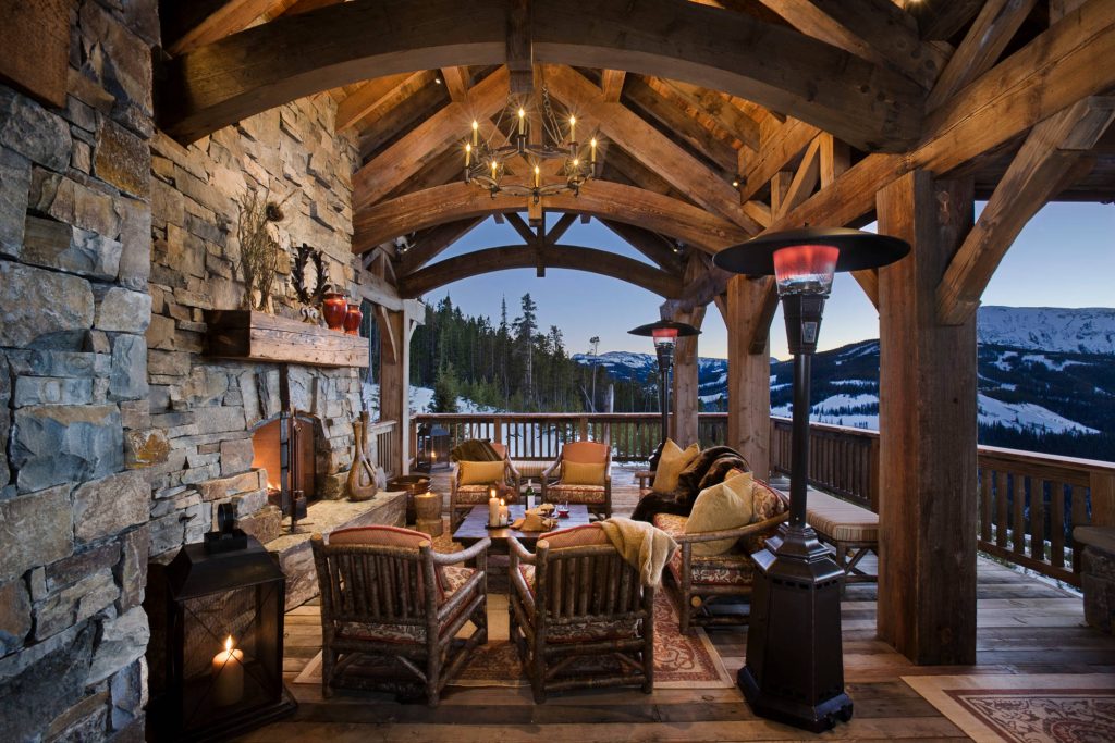 Mountain style porch idea in Other with a fire pit