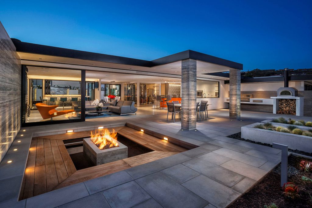 Example of a huge trendy patio design in Orange County with a fire pit and no cover