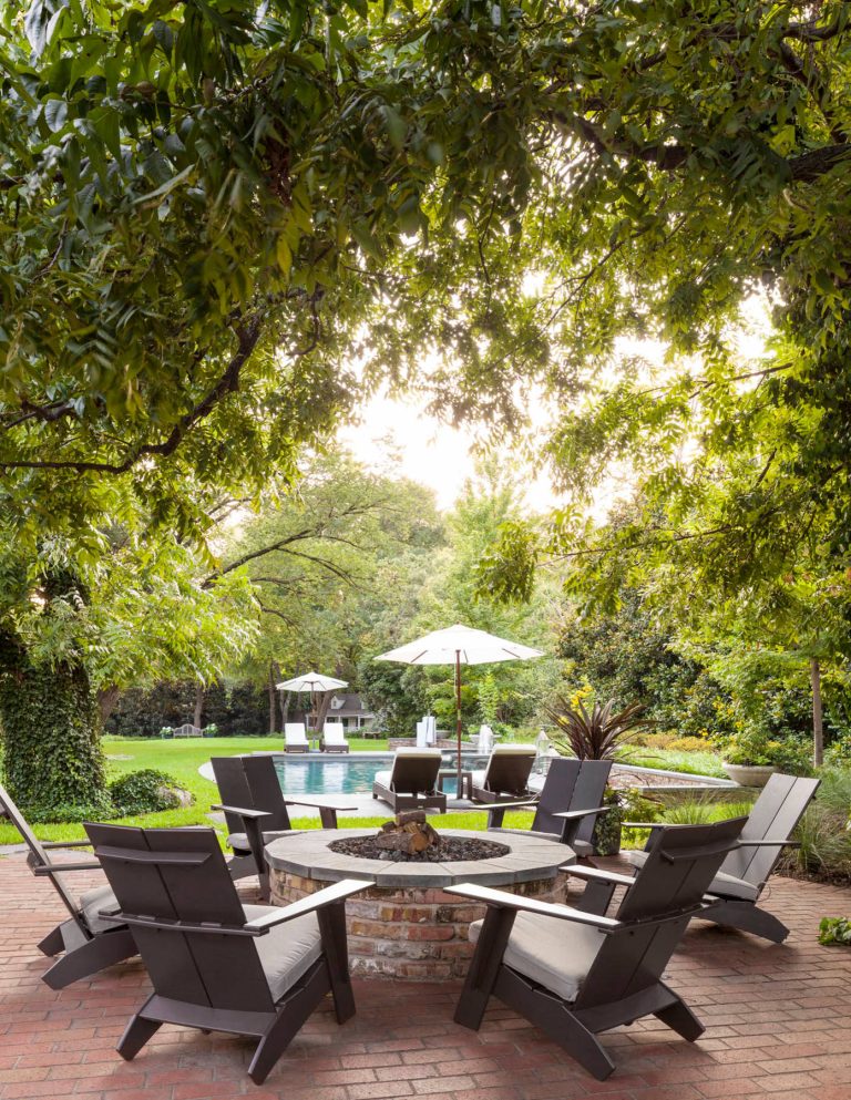 Inspiration for a transitional backyard brick patio remodel in Dallas with a fire pit and no cover