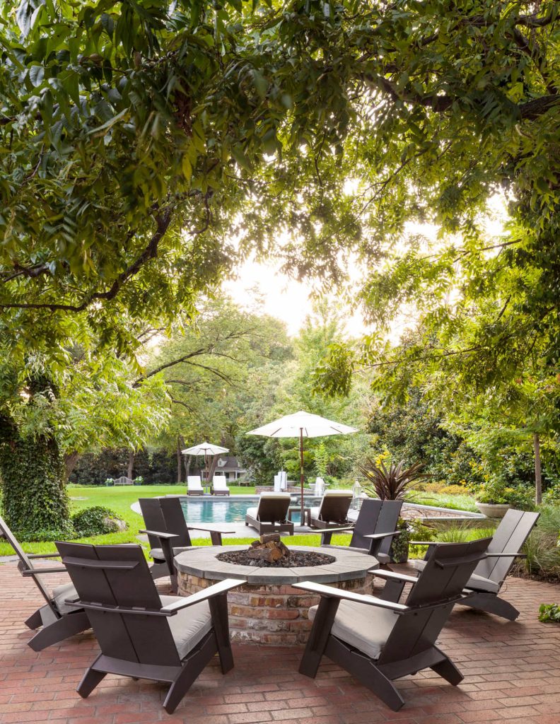 Inspiration for a transitional backyard brick patio remodel in Dallas with a fire pit and no cover