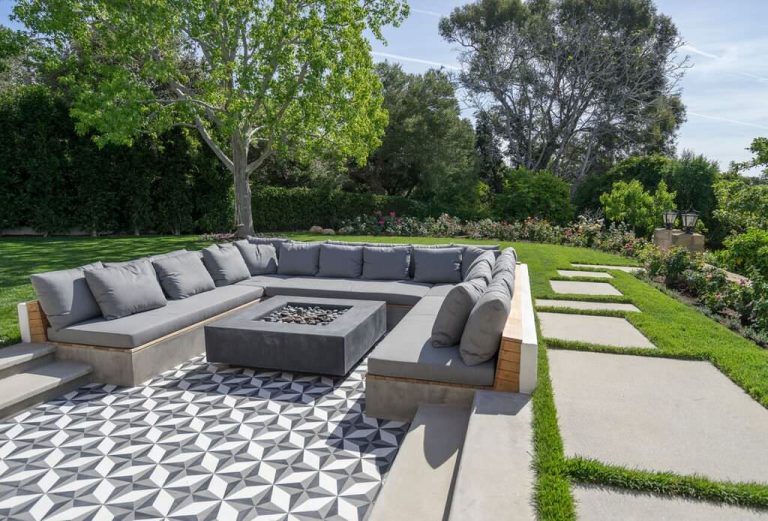 Example of a large trendy backyard tile patio design in Santa Barbara with a fire pit and no cover