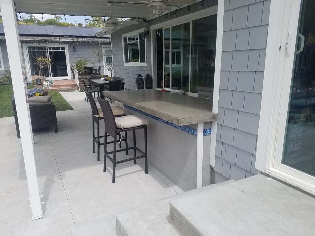 contemporary U-shape island with over hanging bar and mosaic tile strip