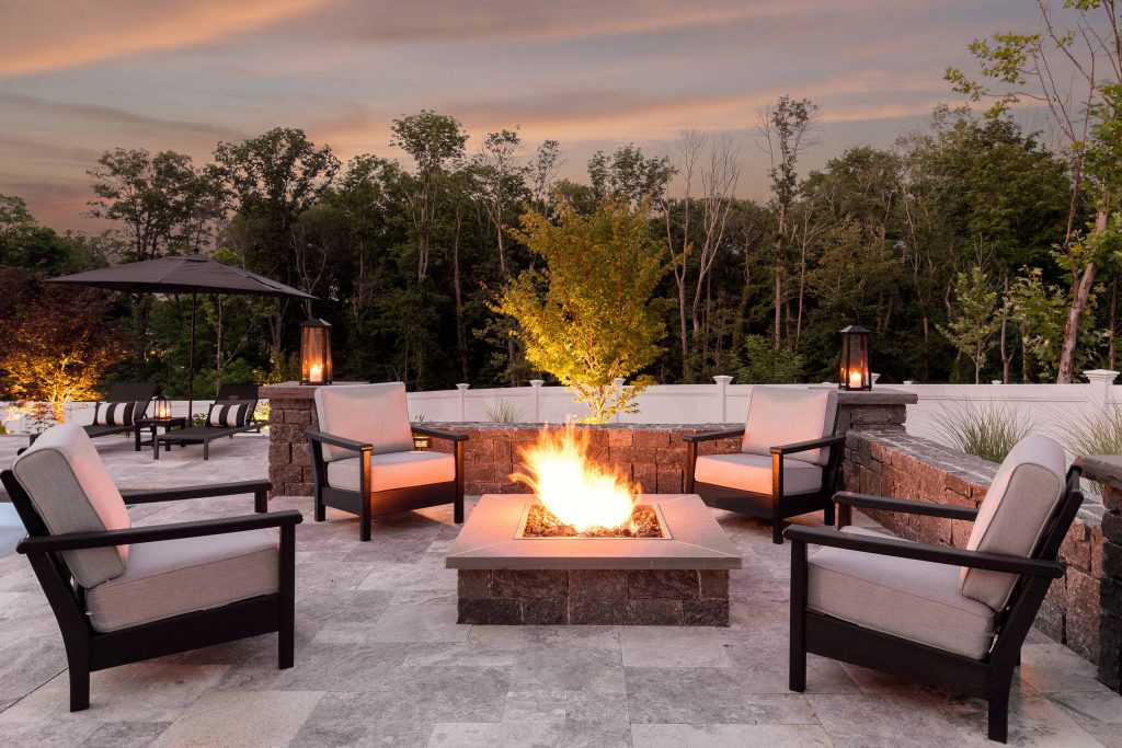 Patio - mid-sized transitional backyard stone patio idea in Boston with a fire pit and no cover