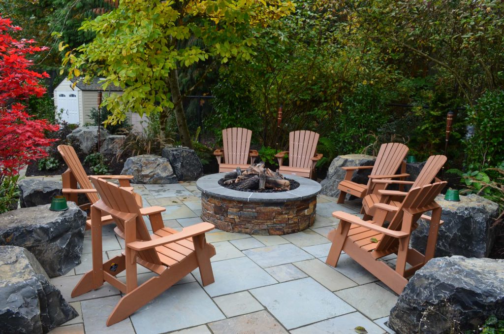 Example of a trendy patio design in Seattle with a fire pit and no cover