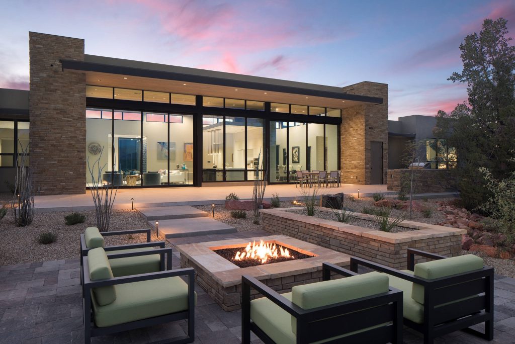 Patio - large contemporary backyard patio idea in Phoenix with a fire pit and no cover