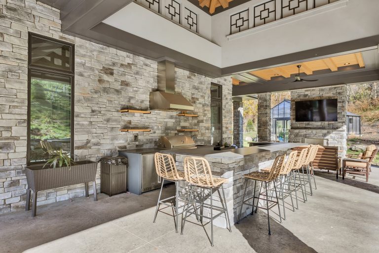 covered rear patio with outdoor kitchen, fireplace and pool