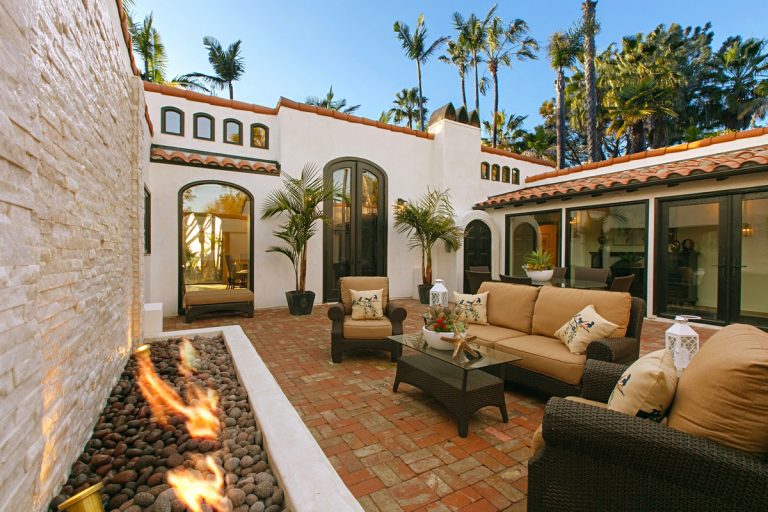 Tuscan courtyard brick patio photo in San Diego with a fire pit and no cover