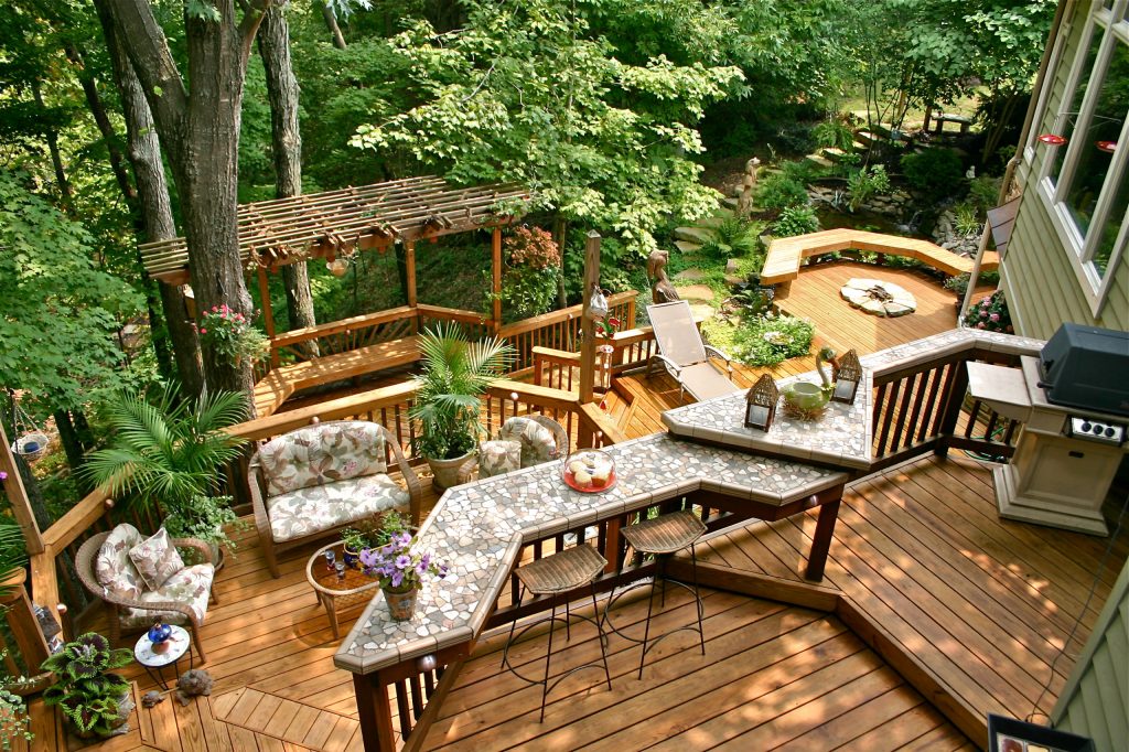 Inspiration for a huge timeless backyard deck remodel in Other with a pergola and a fire pit