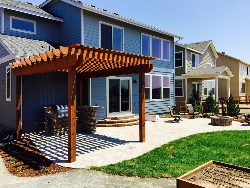 Mid-sized elegant backyard brick patio photo in Denver with a fire pit and a pergola