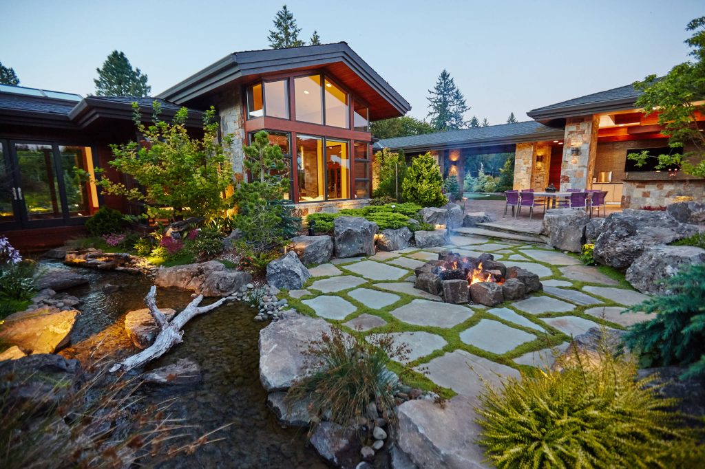 Example of a mountain style patio design in Portland with a fire pit and no cover