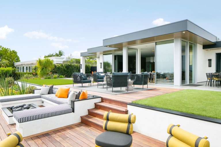 Example of a trendy backyard deck design in Orange County with a fire pit and no cover