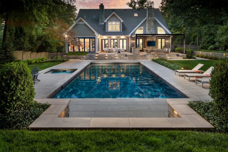 exterior landscaping twilight with pool, spa, and outdoor kitchen by Wheats Landscaping