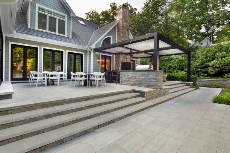 exterior landscaping twilight with pool, spa, outdoor kitchen by Wheats Landscaping