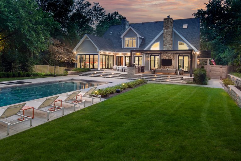 exterior landscaping twilight with pool, spa, outdoor kitchen by Wheats Landscaping