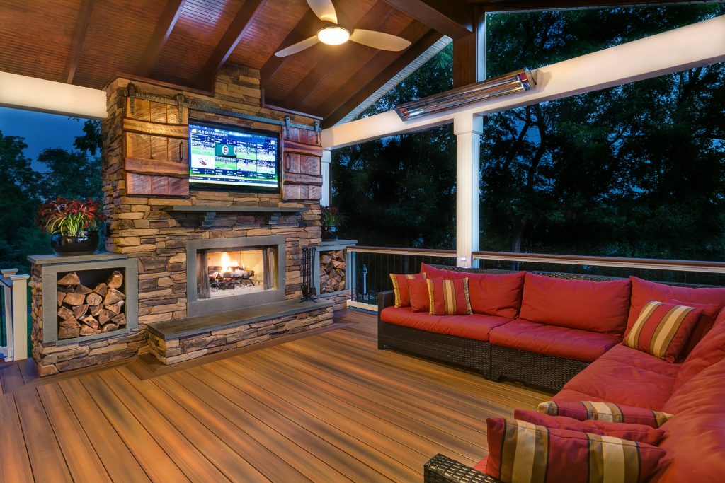 This outdoor retreat features -- what else -- but low-maintenance Fiberon composite decking! Barn doors cover the outdoor TV, while the heat lamp and fireplace provide comfort when the temperature drops. Find out where to buy Fiberon at https://www.fiberondecking.com/start-your-project/where-to-buy by Fiberon Decking | Fire Pits|Backyard Design|Outdoor Living Spaces|Landscape Design|Backyard Ideas|Landscaping|Landscaping Ideas|Landscape Installation|Fire Feautures|Fire Pit
