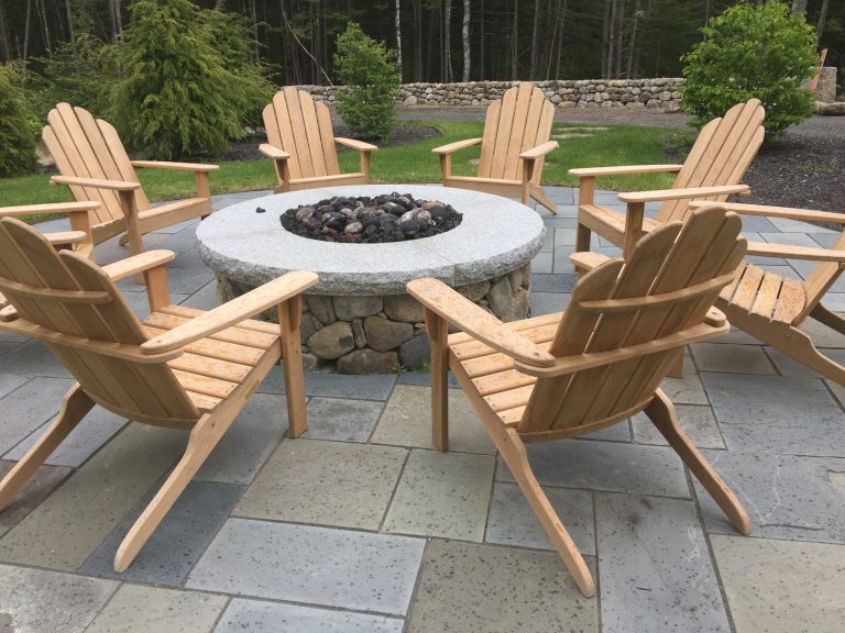 natural stone firepit with thermaled granite capstones. Square-rectangular bluestone terrace