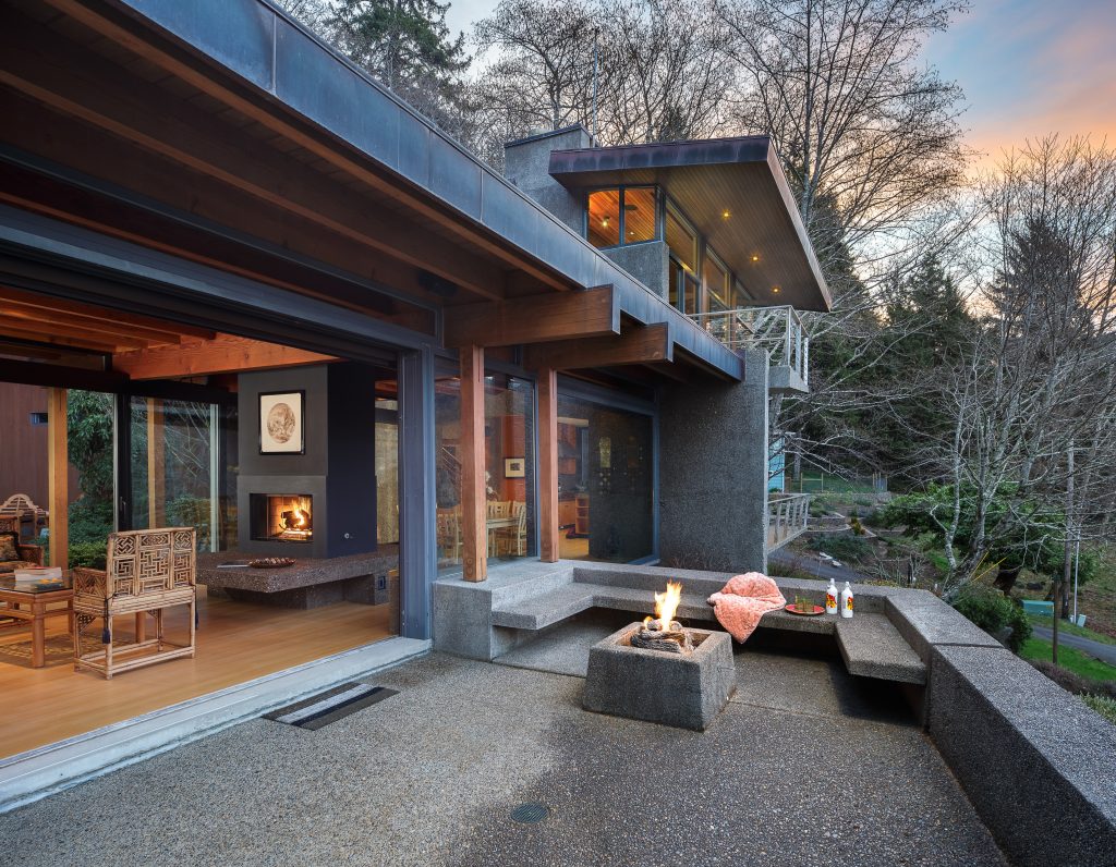 Inspiration for a large asian front yard concrete patio remodel in Other with a fire pit and a roof extension
