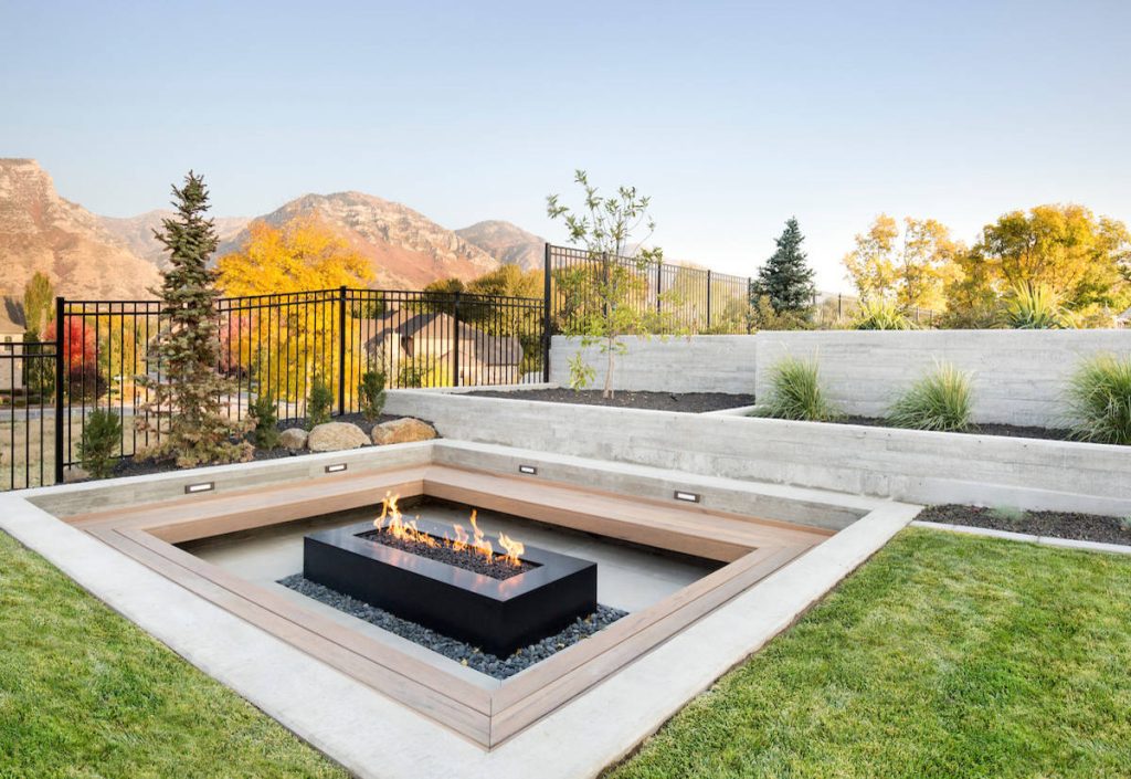 Example of a trendy concrete patio design in Salt Lake City with a fire pit and no cover
