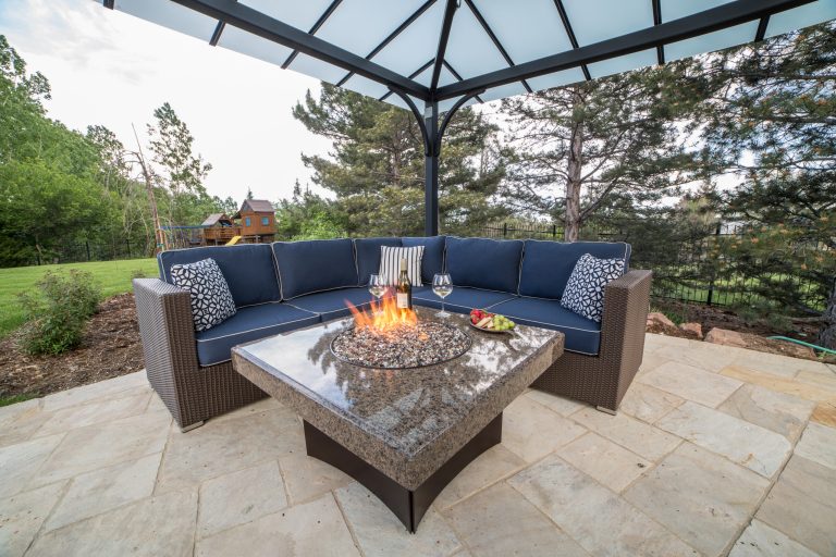 Featuring a 5-Piece Terrace Collection L Sectional from All Backyard Fun. This gorgeous L sectional is seated next to a Tropical Elegance 40" Square Oriflamme Fire Table.