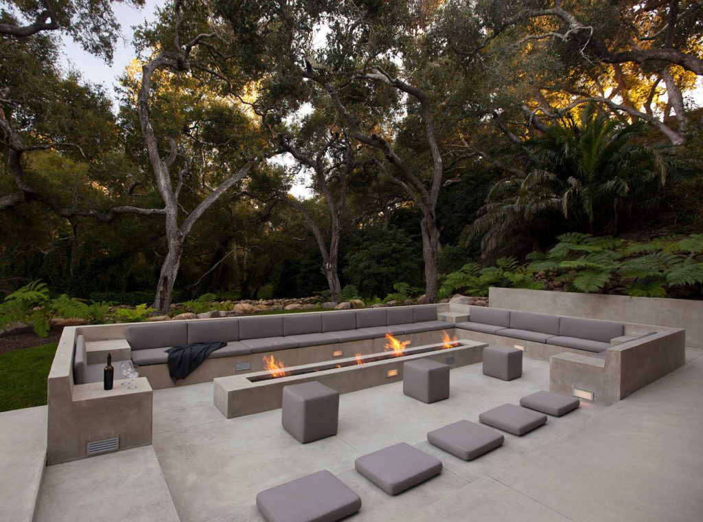 Inspiration for a modern concrete patio remodel in Los Angeles with a fire pit and no cover
