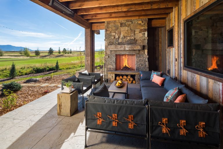 Mountain style porch photo in Other with a fire pit and a roof extension by Dovetail Construction | Outdoor Photos | Porch | Landscaping | Landscape Design | Outdoor Living Space | Porch Design Ideas | Outdoor Living Space Ideas | Backyard Design