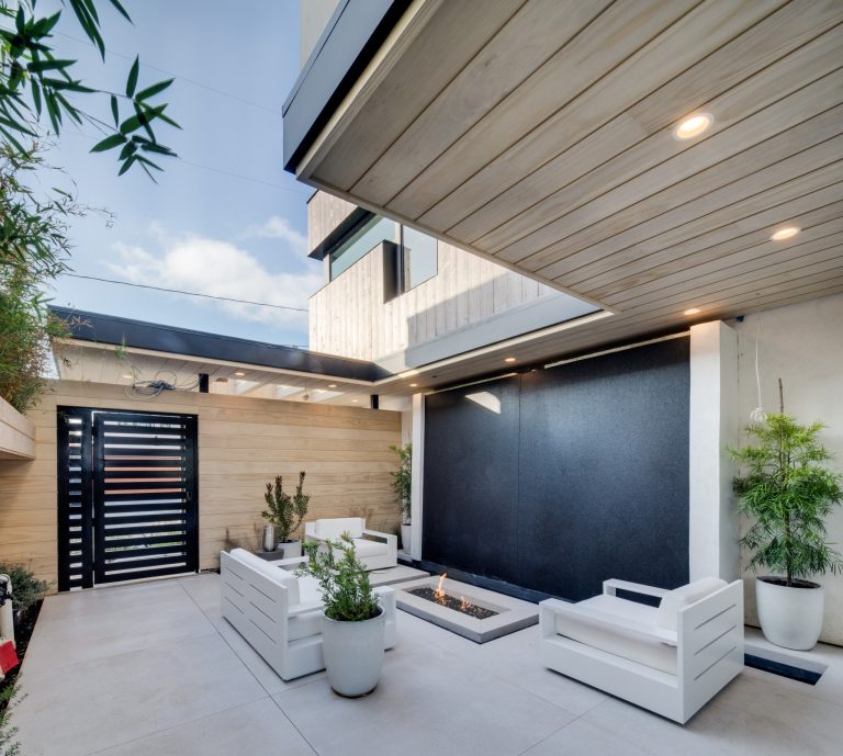 Trendy patio photo in Orange County with a fire pit and a roof extension
