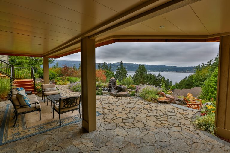 Second level cedar deck with aluminum railing and beautiful landscaping. This project has an under deck ceiling under a portion of the deck to keep it dry year-round. This project also includes a fire pit and hot tub.