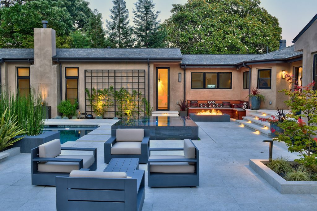 Example of a large trendy backyard tile patio design in San Francisco with a fire pit and no cover