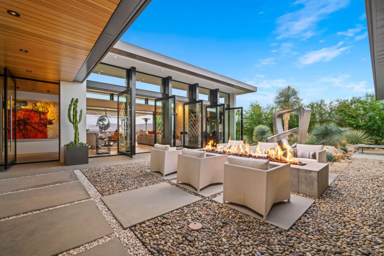 Example of a trendy courtyard patio design in Los Angeles with a fire pit and no cover